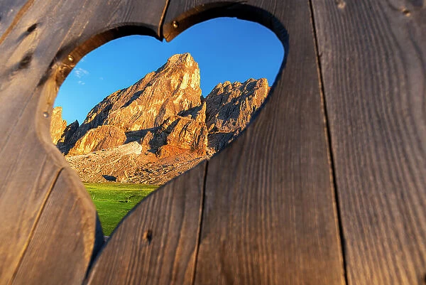 View of the Sass de Putia through a heart shaped hole at dusk, Passo delle Erbe, Dolomites, South Tyrol, Italy, Europe