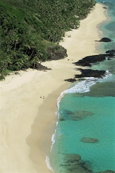 View down west coast of Yasawa Island, with two figures on beach, Fiji
