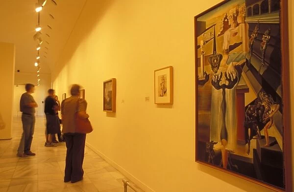 Visitors to the art gallery studying Salvador Dali s