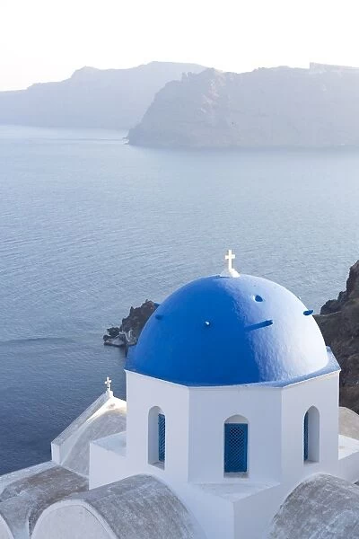 White church with blue dome overlooking the Caldera, Oia, Santorini, Cyclades Islands