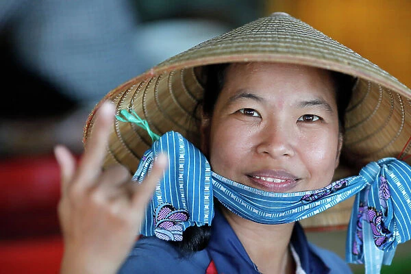 Woman with the traditional Vietnamese conical hat working in a fish factory, Vung Tau, Vietnam, Indochina, Southeast Asia, Asia
