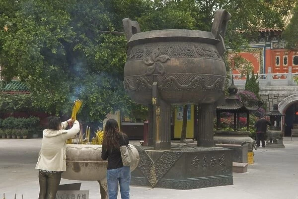 Worshippers at the Po Lin Monastery, Lantau Island, Hong Kong, China, Asia