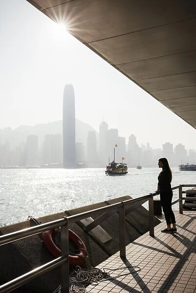 Young woman standing on Tsim Sha Tsui Waterfront, Kowloon, Hong Kong, China, Asia