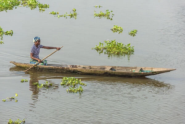 Africa, Benin, Lake Nokoua. A woman in her traditional wooden boat in the famous