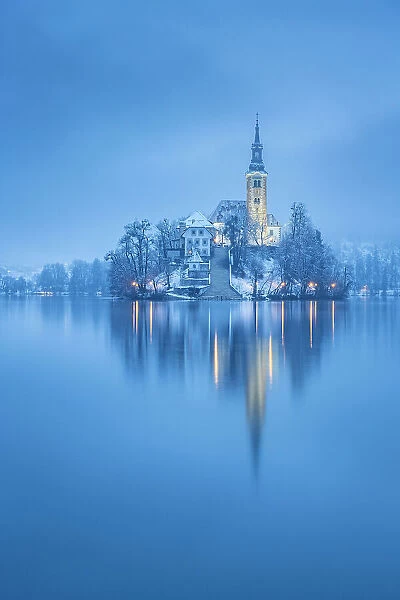 Assumption of Mary's Pilgrimage Church and Bled Island in snow, Lake Bled, Slovenia