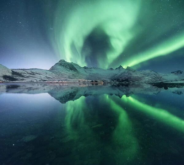 Aurora borealis over a lake near Svolvaer, Lofoten islands, Norway
