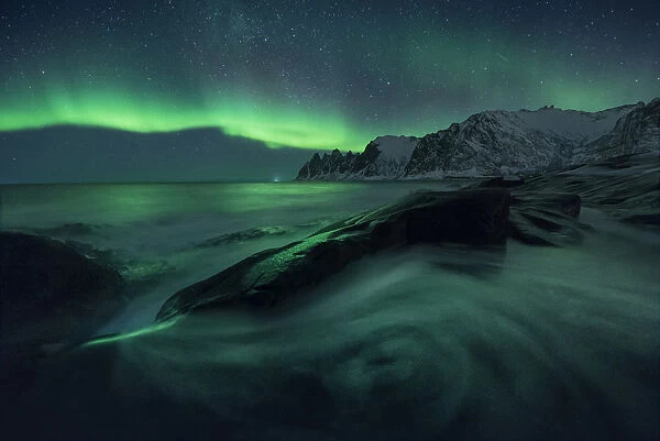 Aurora borealis over Tungeneset and the Okshornan Peaks, Senja Island, Norway