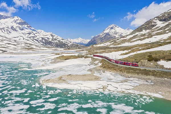 Bernina Express train at Lago Bianco during thaw, Bernina Pass, canton of Graubunden