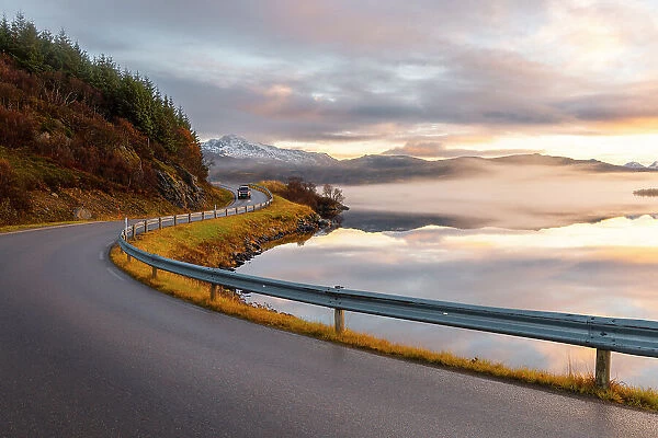 A car along along the road to Uttakleiv beach during sunset, Leknes, Vestvagoy, Nordland, Lofoten Islands, Norway