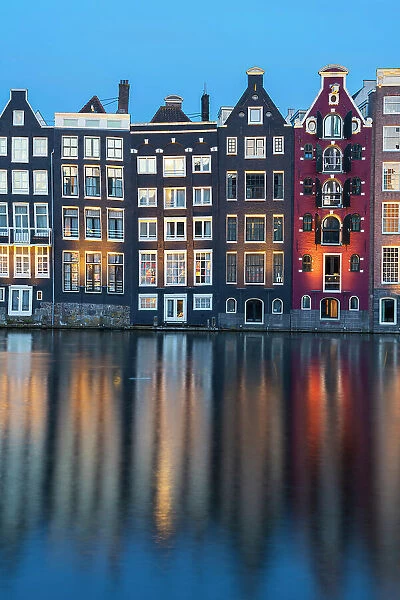 Dancing houses near river at twilight, Damrak, Amsterdam, Netherlands
