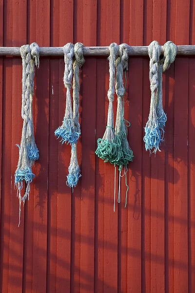 Fishing nets hanging from Rorbuer exterior, Storvagen, Austvagsoya, Lofoten, Nordland