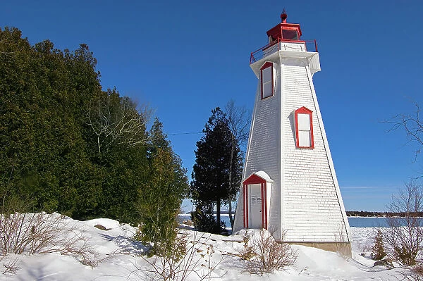 Lighthouse on Georgian Bay in winter Tobermory, Ontario, Canada