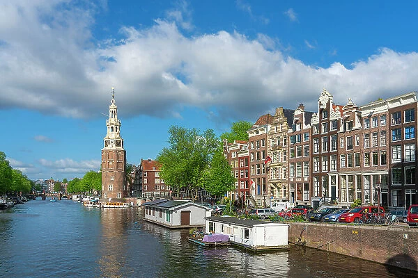 Montelbaanstoren tower by Oudeschans canal against sky, Amsterdam, North Holland, Netherlands