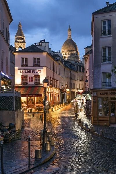 Montmartre at night with illuminated Sacre Coeur Basilica in the background, Paris