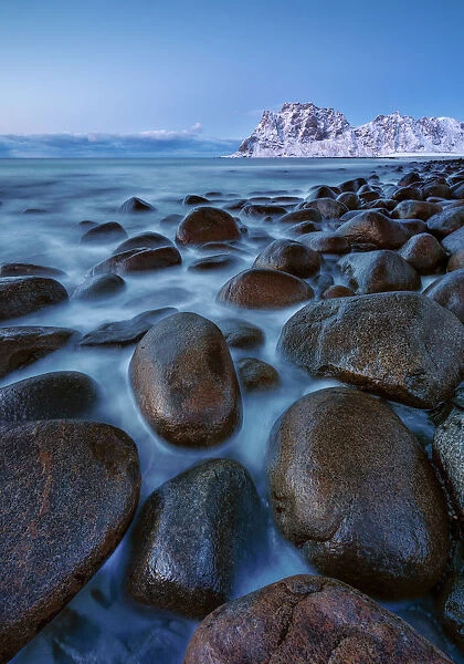 Rocks into the water at Uttakleiv beach at twilight, Leknes, Lofoten, Nordland, Norway