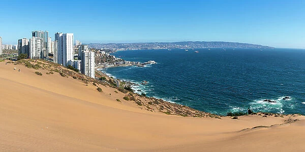 Sand dunes with high-rise buildings on coast and distant view of Vina del Mar and Valparaiso, Concon, Valparaiso Province, Valparaiso Region, Chile
