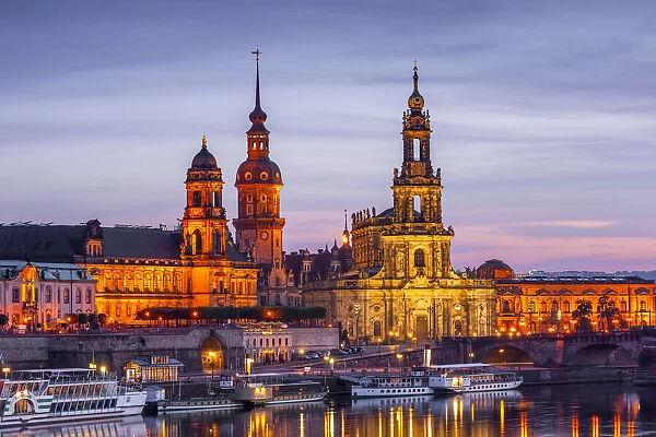 Skyline of Dresden at dusk with Bruehl's Terrace, Academy of Fine Arts, Residential palace, Court Church - Hofkirche and paddle steamer on river Elbe, Dresden, Saxony, Germany