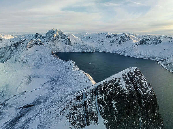 Sunrise over the snowcapped Segla mountain overlooking a fjord, aerial view, Senja, Troms county, Norway