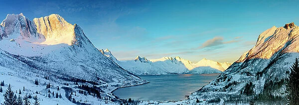 Sunrise over the snowy Breidtinden mountain and Mefjordbotn in winter, Mefjorden, Senja, Troms county, Norway