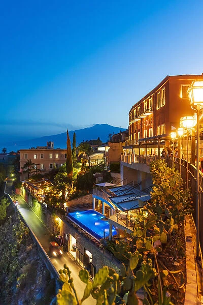 Taormina, Sicily. Luxury hotel by night with Etna volcano in the background