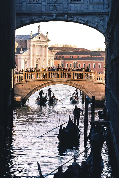 Venice, Veneto, Italy. Gondolas passing under the Bridge of Sighs