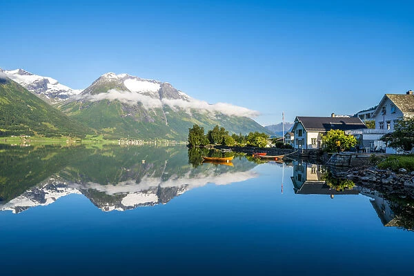 Village of Hjelle and mountains mirrored in Oppstrynsvatn lake, Oppstryn