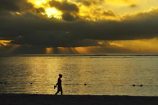 Woman walks along Le Morne beach, Mauritius, Indian Ocean, MR