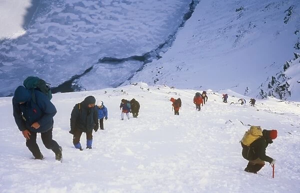 mountaineers climbing Helvellyn in the Lake district, UK, in winter. Such winter climbing conditions used to be a regular occurence. Climate change has lead to a succession of warmer winters, making freezes like this a rare