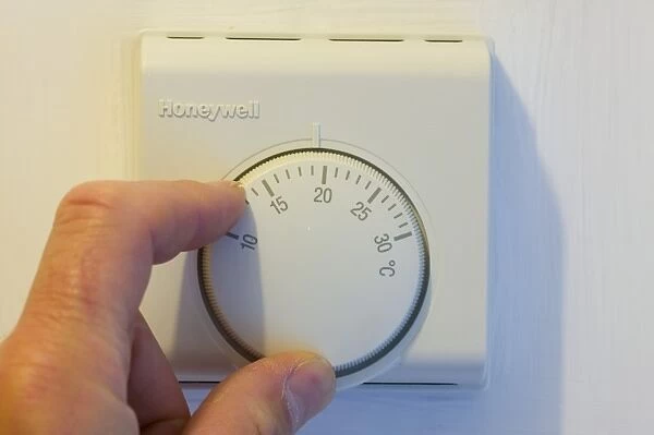 setting the central heating thermostat at a cooler temperature to save energy