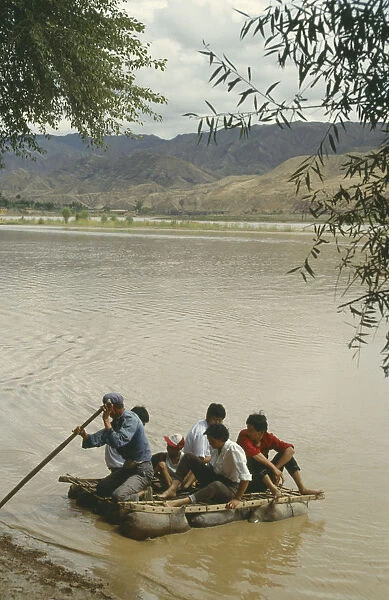 10014633. CHINA Yellow River People traveling off on a Hide Raft