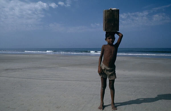 10015527. INDIA Goa Colva Beach Young boy from Karnataka selling drinks on the beach