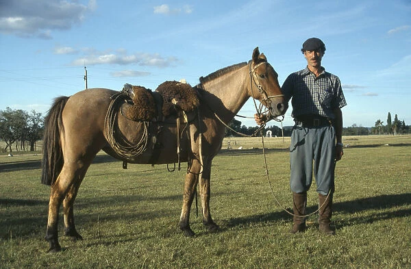 20047753. URUGUAY Farming Gaucho holding horse