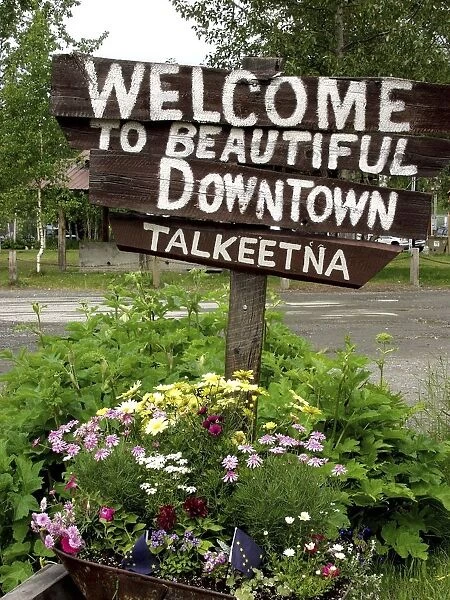 20064561. USA Alaska Talkeetna Wooden welcome sign standing in flower tub