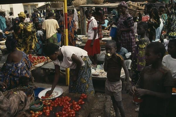 20073993. MALI Kayes Busy market scene with brightly dressed women