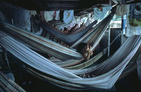 BRAZIL, Amazon, Transport Child lying in hammock accommodation on Amazon river boat