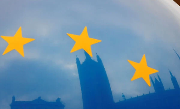 The Houses of Parliament are reflected in an EU flag balloon in London