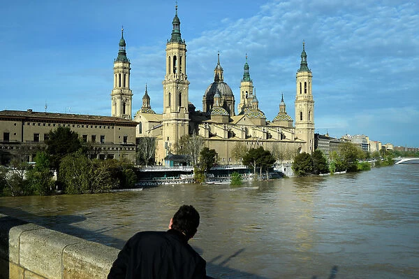 A man observes the River Ebro close to overflowing, following heavy rains and snow melt