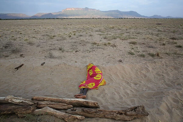 A Turkana man sleeps on the western shore of Lake Turkana close to Todonyang near the