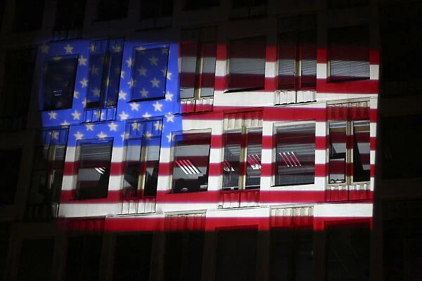U. S. flags are projected on facade of the U. S. Embassy, during during the U. S