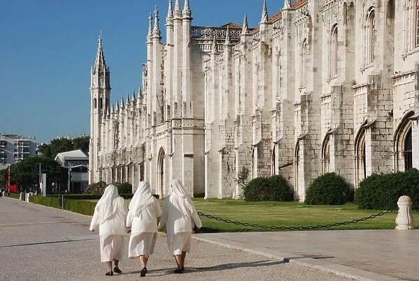Three nuns walking outside late-Gothic Monastery, Hieronymites Monastery (Mosteiro dos Jeronimos), Belem, Lisbon