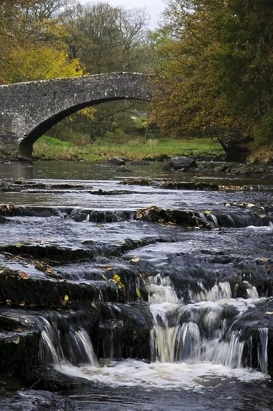 View of river cascades and old pack-horse bridge, Stainforth Force, River Ribble, Yorkshire Dales N. P