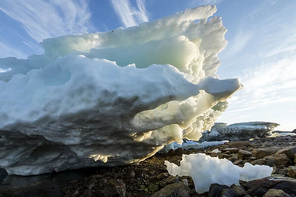 Canada, Nunavut Territory, Melting iceberg stranded by low tide along Frozen Channel