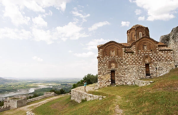 The Hagia Triada Church. View over the valley. A woman standing on a wall taking a photograph