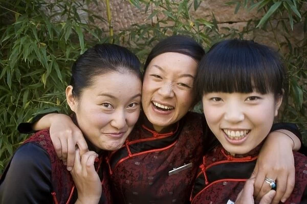 Reception girls in Naxi-style dress at spa resort, Jade Dragon Snow Mountain Valley outside Lijiang