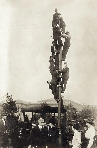 BASEBALL: SPECTATORS, 1909. Spectators on a utility pole at a World Series game