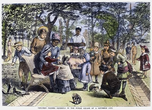 CHILDREN AND NANNIES, 1881. Children with their nannies feeding squirrels in the public square of a city in the American south. Wood engraving, American, 1881
