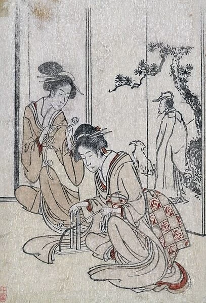 CHINA: WOMEN AND SAGE. Two young Chinese women braiding a cord before a screen