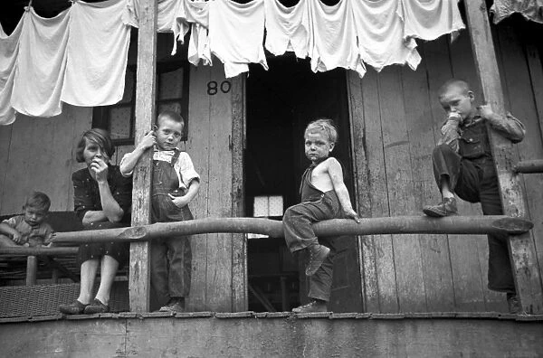 COAL MINERs FAMILY, 1938. Wife and children of a coal miner sitting on a porch in Pursglove