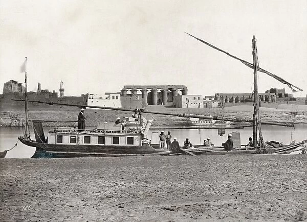 EGYPT: LUXOR. Several men with a boat on the Nile River at Luxor, Egypt, with the