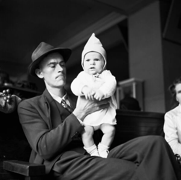 FATHER AND CHILD, 1943. A father and child in a Greyhound bus terminal, somewhere